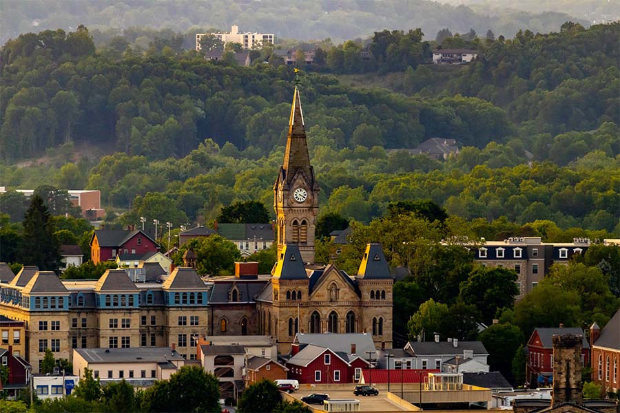 Hollidaysburg PA - Aerial View of Downtown Hollidaysburg Pennsylvania with Views of a Church Commercial Buildings and Homes Surrounded by Green Trees