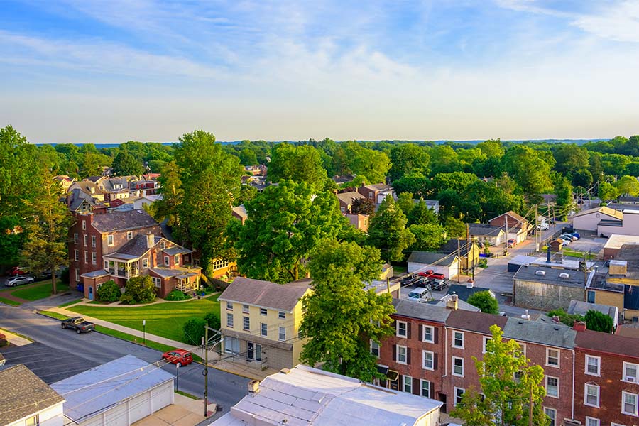 West Chester PA - Aerial View of Main Street in West Chester Pennsylvania with Homes Surrounded by Green Trees