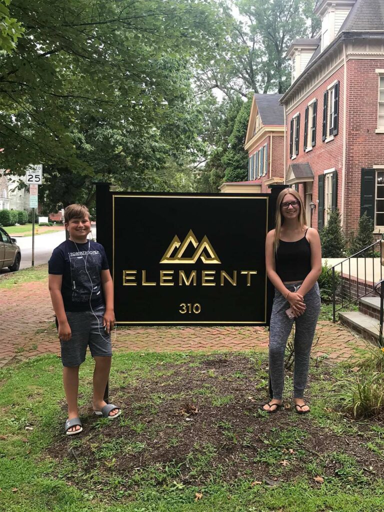 Blog - Portrait of Andreas Kids Standing Next to the Element Risk Management Sign Outdoors