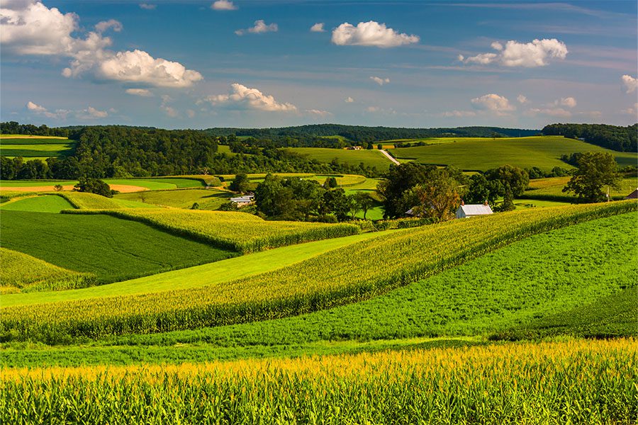 Mcconnellsburg PA - Rural Farm Fields Rolling Hills Southern Pennsylvania With Blue Cloudy Sky Farmland